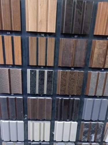 Numbered display board of fluted wall panel samples in assorted wood and stone finishes
